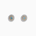 The 18K Two Tone Gold Certified Natural Blue and White Diamond Stud Earrings feature a central blue gemstone framed by two rows of natural diamonds in a circular design with elegant gold details.