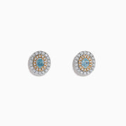 The 18K Two Tone Gold Certified Natural Blue and White Diamond Stud Earrings feature a central blue gemstone framed by two rows of natural diamonds in a circular design with elegant gold details.
