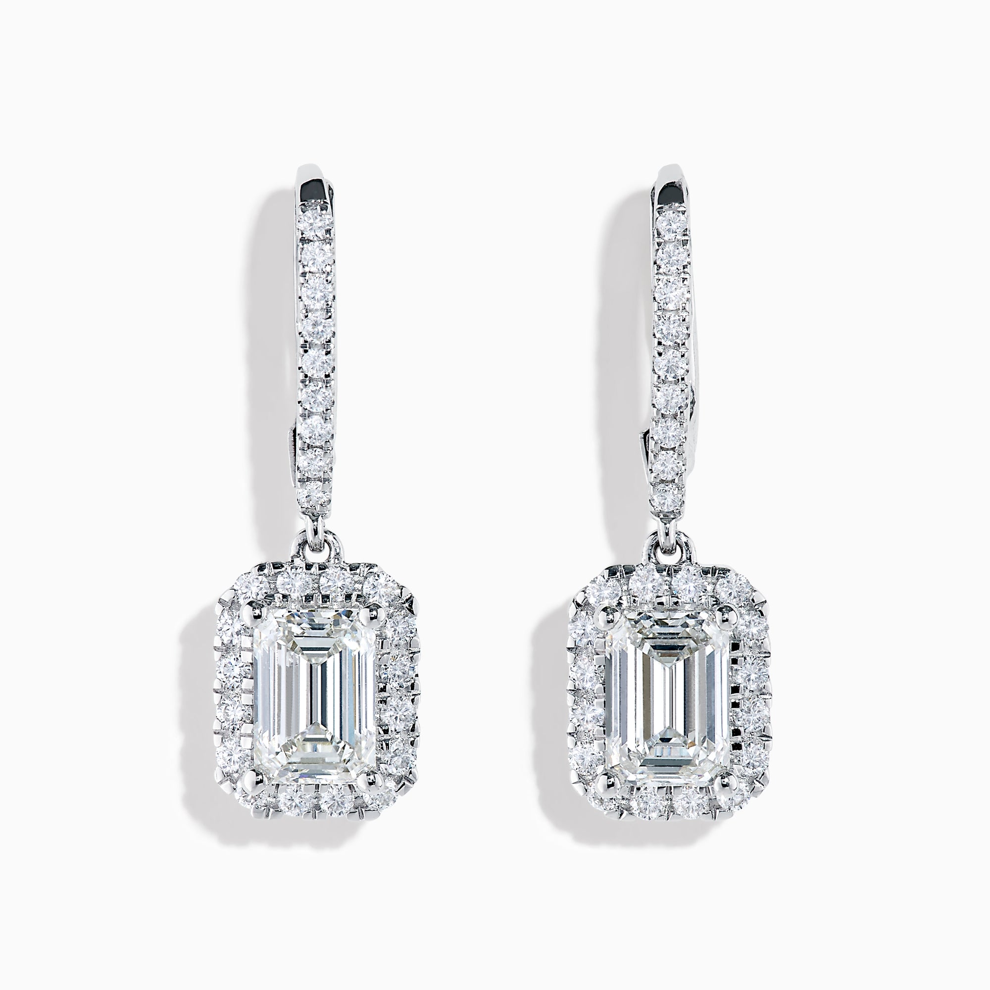 The Lab Grown Diamond Emerald Cut Dangle Earrings in 14K White Gold showcase emerald cut lab grown centers with a halo of round diamonds and diamond-encrusted hooks, elegantly presented against a white background.