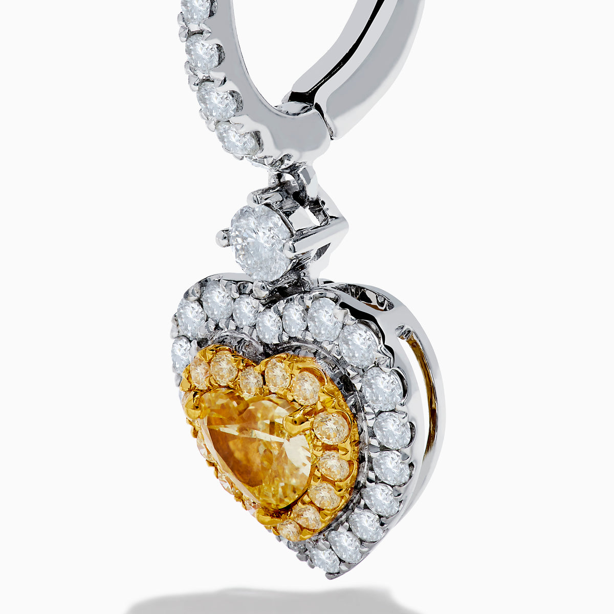 The Canare 18K Two Tone Gold White & Yellow Diamond Heart Earrings feature heart-shaped yellow stones, a halo of white diamonds, and diamond-accented hooks for elegant sparkle.