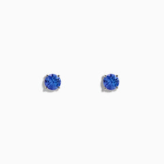 14K White Gold Tanzanite Stud Earrings featuring round blue gemstones in white gold prongs are displayed against a plain white background.
