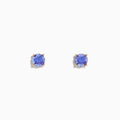 The 14K Yellow Gold Tanzanite Stud Earrings each showcase a round, faceted tanzanite in a four-prong setting, displayed on a white background.