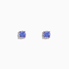 The 14K Yellow Gold Tanzanite Stud Earrings each showcase a round, faceted tanzanite in a four-prong setting, displayed on a white background.