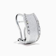 A pair of 925 Sterling Silver Diamond Accented Huggie Earrings, featuring sparkling diamond accents, is displayed on a plain white background.