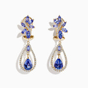 14K yellow gold tanzanite and diamond earrings featuring marquise and pear-shaped blue stones, accented with diamonds in a floral cluster at the top and a teardrop dangle design below.