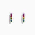 Watercolors 14K White Gold Multi Sapphire Huggie Hoop Earrings featuring multicolored sapphires set in a vertical line, showcased against a plain white background.