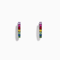 Watercolors 14K White Gold Multi Sapphire Huggie Hoop Earrings featuring multicolored sapphires set in a vertical line, showcased against a plain white background.