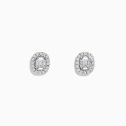 The Classique 14K White Gold Diamond Stud Earrings 0.59 TCW feature oval studs with central baguette-cut diamonds, each encircled by a halo of sparkling round stones.