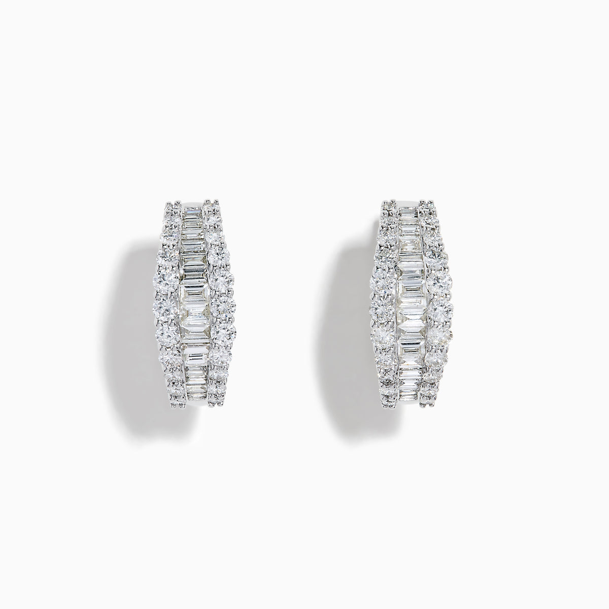 The Classique 14K White Gold Diamond Hoop Earrings feature rows of rectangular and round-cut diamonds, offering a sparkling and timeless look, beautifully displayed on a plain white background.