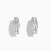 The Classique 14K White Gold Diamond Hoop Earrings feature rows of rectangular and round-cut diamonds, offering a sparkling and timeless look, beautifully displayed on a plain white background.