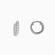 Pave Classica 14k White Gold Diamond Huggie Earrings, each featuring a row of sparkling diamonds along the front, are shown against a plain white background.