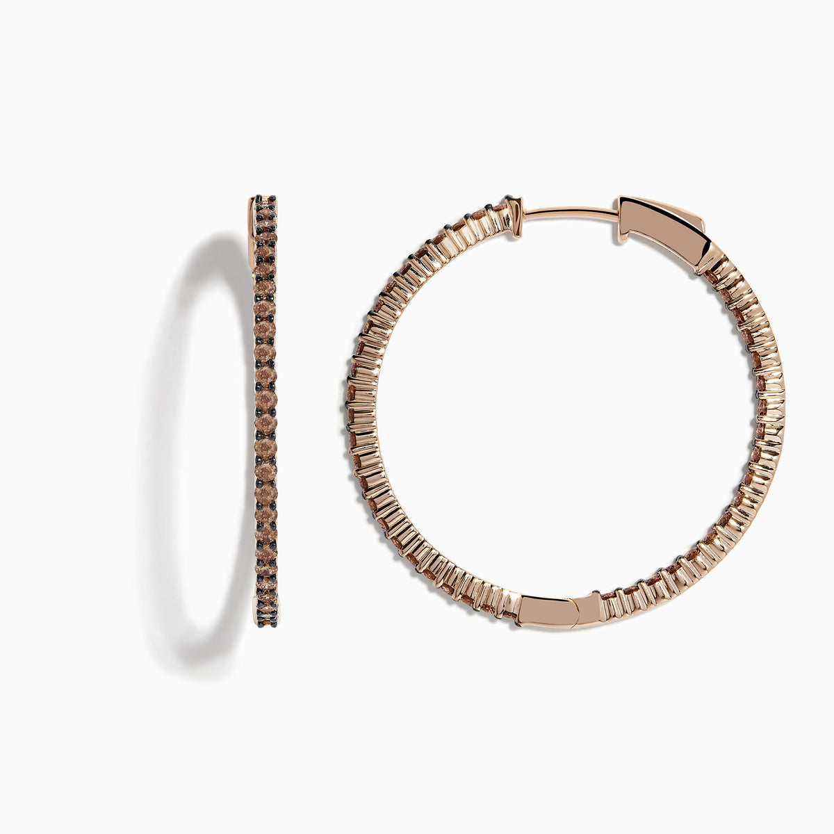 The 14K Rose Gold Brown Diamond 1.5 Inch Hoop Earrings, featuring slim vertical hoops with dark brown diamonds, are photographed against a plain white background, casting soft oval-shaped shadows to the left.