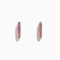 A pair of 14k Yellow Gold Pink Sapphire Huggie Earrings displayed against a plain white background.