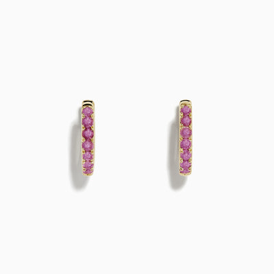 A pair of 14k Yellow Gold Pink Sapphire Huggie Earrings displayed against a plain white background.