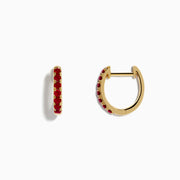 Ruby Royale 14k Yellow Gold Ruby Huggie Earrings: Small yellow gold hoops featuring a single row of red rubies, elegantly displayed against a plain white background.