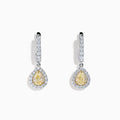 The 18K Two Tone Gold White and Yellow Diamond Drop Earrings feature teardrop-shaped yellow gems encircled by white diamonds, set in two tone gold, with diamond-studded hooks for extra brilliance.