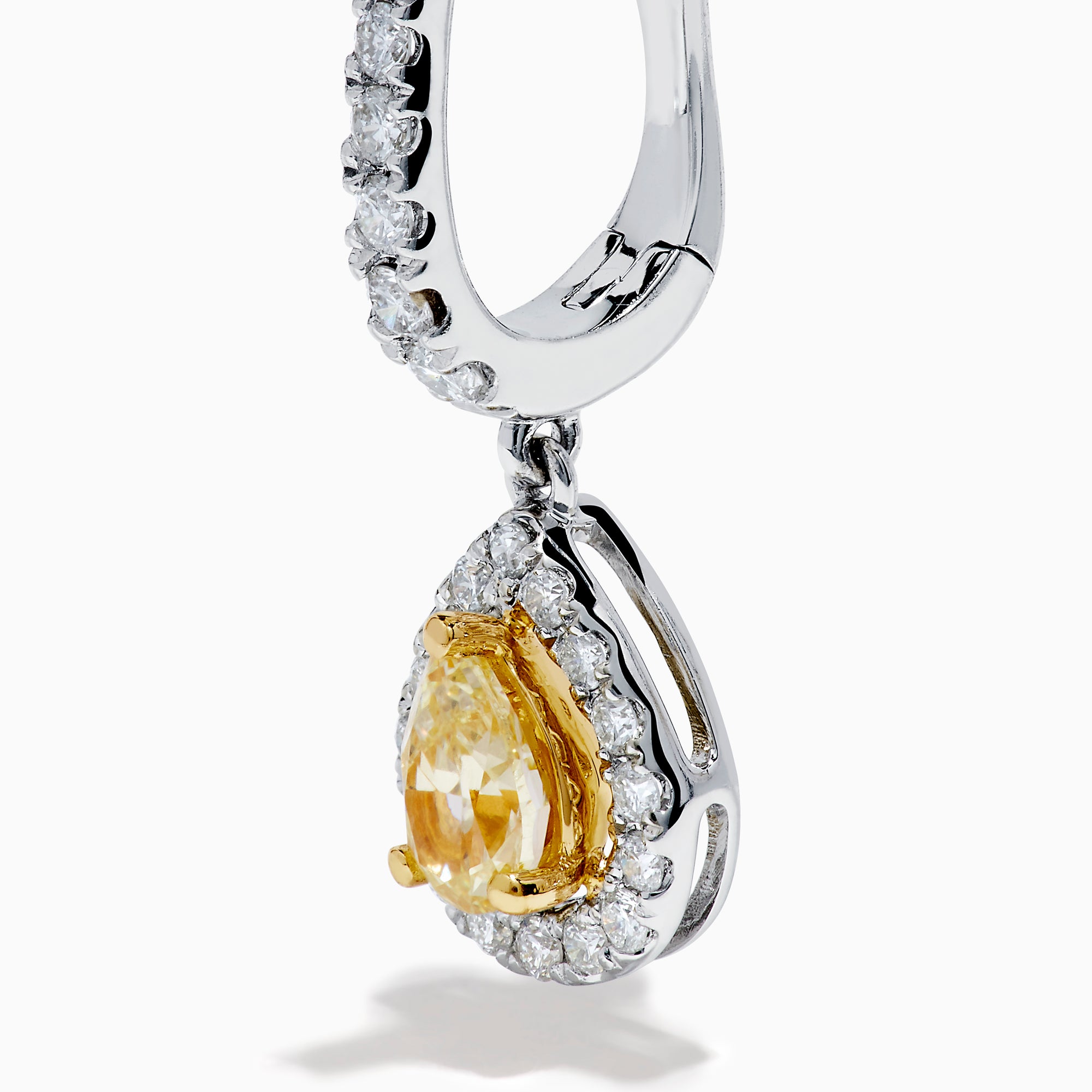 The 18K Two Tone Gold White and Yellow Diamond Drop Earrings feature teardrop-shaped yellow gems encircled by white diamonds, set in two tone gold, with diamond-studded hooks for extra brilliance.