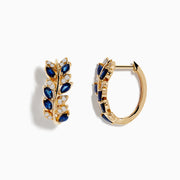 The Royale Bleu 14K Yellow Gold Earrings feature a leaf design with alternating blue sapphires and diamonds on the front. One earring is shown from the front, the other from the side, both on a white background.