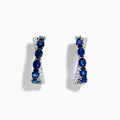 The Royale Bleu 14K White Gold Blue Sapphire and Diamond Hoop Earrings feature alternating oval blue sapphires and sparkling diamonds, all set in a white gold band and displayed against a white background.