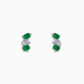 A pair of 14K white gold stud earrings featuring emerald gemstones, white sapphires, and diamonds.