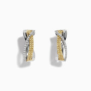 The Canare 14k Two Tone Yellow and White Diamond Hoop Earrings 5/8 feature intertwined yellow and white gold bands adorned with diamonds, beautifully displayed on a plain white background for a striking look.