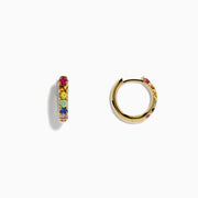 A pair of Watercolor 14k Gold Multi Sapphire Huggie Earrings featuring small gold hoops set with multicolored sapphires in a row, displayed on a plain white background.