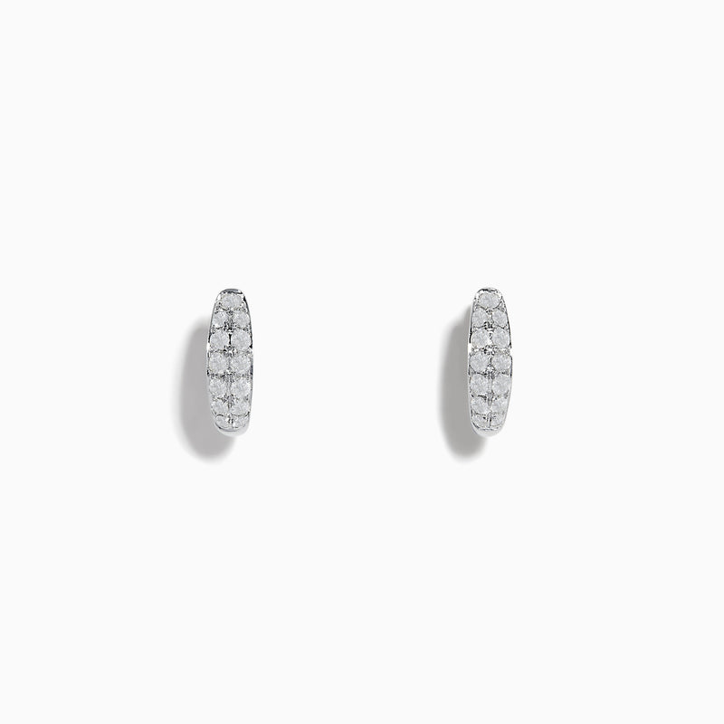 The Pave Classica 14k White Gold Diamond Huggie Earrings showcase elegant white gold design with sparkling diamonds, beautifully displayed against a plain white background.