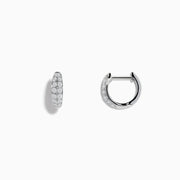 The Pave Classica 14k White Gold Diamond Huggie Earrings showcase elegant white gold design with sparkling diamonds, beautifully displayed against a plain white background.
