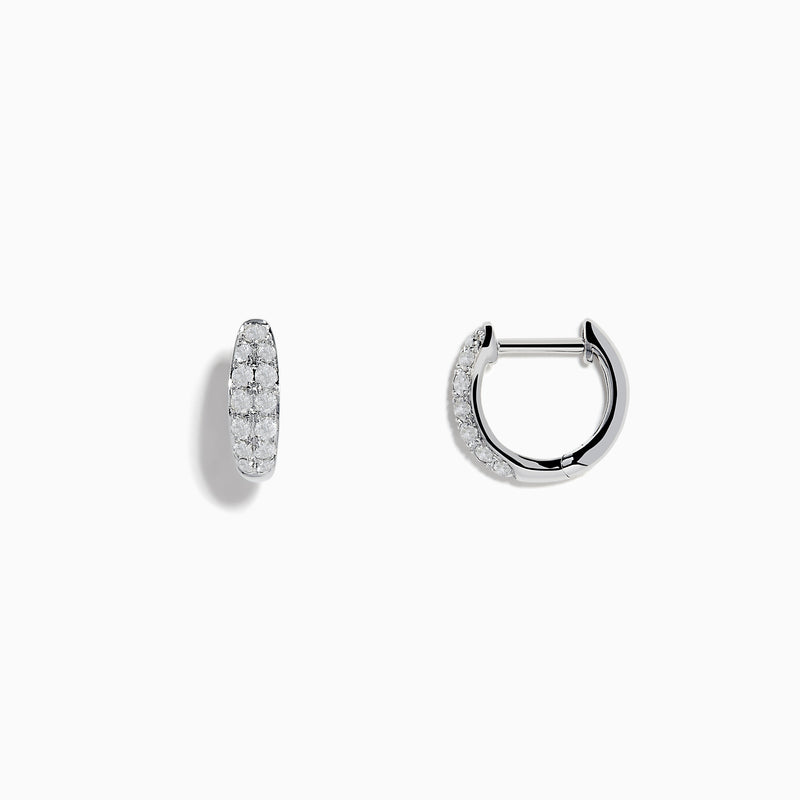 The Pave Classica 14k White Gold Diamond Huggie Earrings showcase elegant white gold design with sparkling diamonds, beautifully displayed against a plain white background.