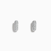 A pair of Pave Classica 14k White Gold Diamond Huggie Earrings, featuring rows of sparkling white diamonds, is displayed on a plain white background.