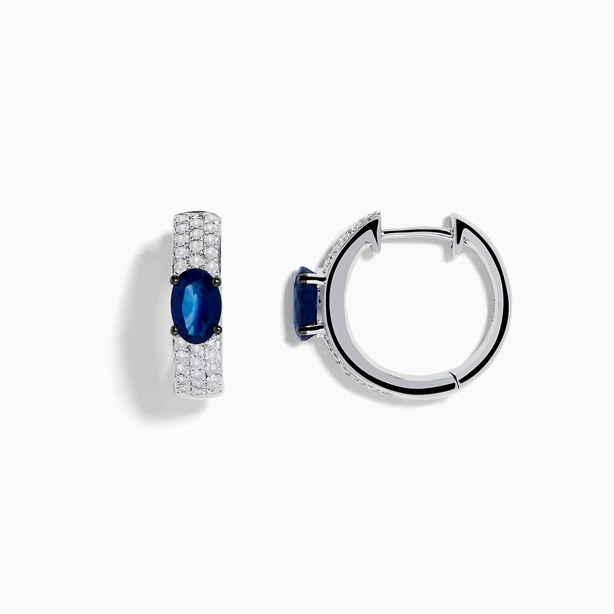 The Royal Bleu 14K White Gold Sapphire and Diamond Huggie Earrings showcase oval sapphire centers surrounded by rows of sparkling diamonds, displayed against a plain white background.