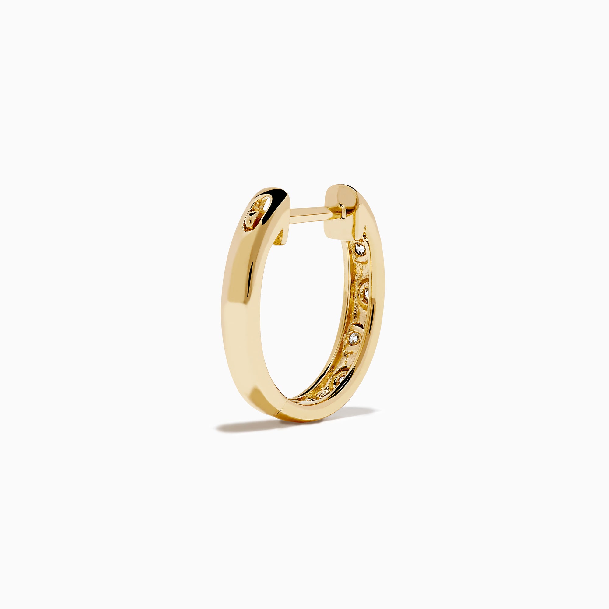 The D'Oro 14K Yellow Gold Diamond Huggie Earrings each feature three round white diamonds set vertically and are displayed against a plain white background.