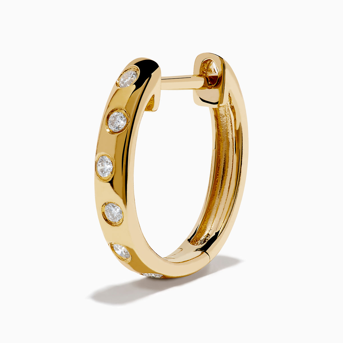 The D'Oro 14K Yellow Gold Diamond Huggie Earrings each feature three round white diamonds set vertically and are displayed against a plain white background.