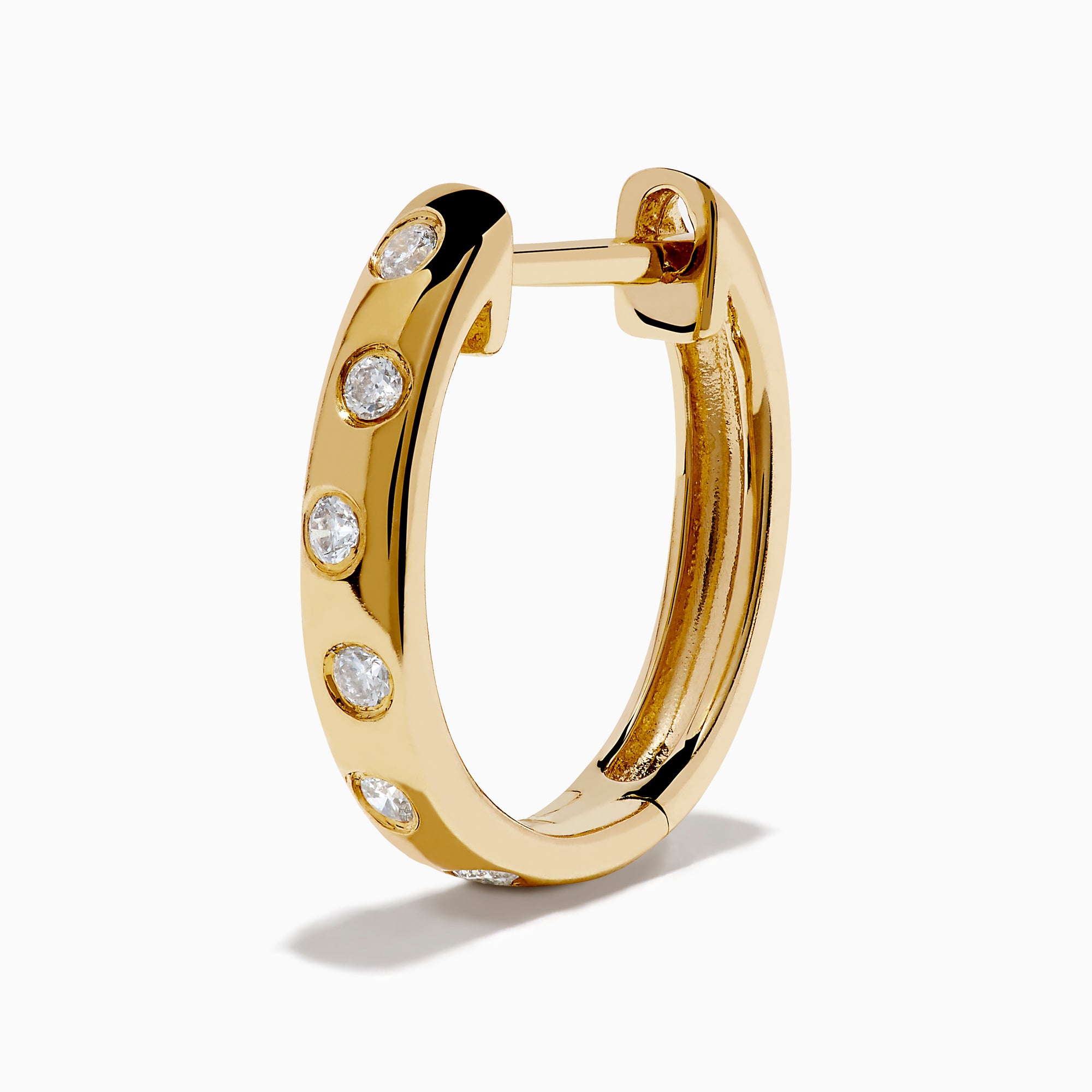 The D'Oro 14K Yellow Gold Diamond Huggie Earrings each feature three round white diamonds set vertically and are displayed against a plain white background.