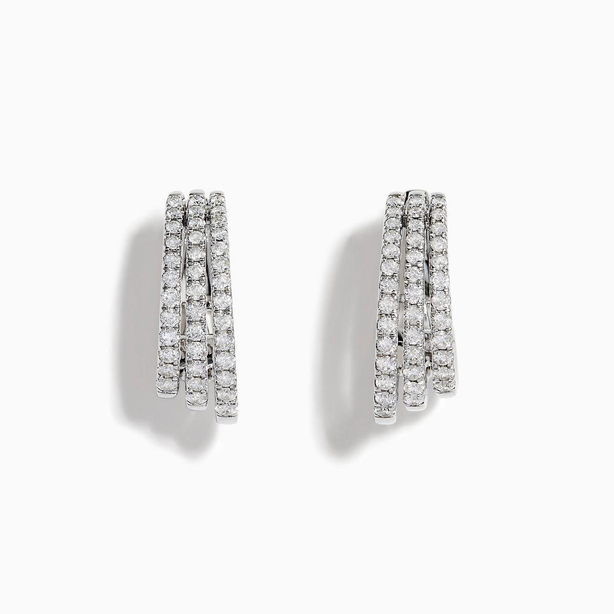 Elegant 14K White Gold Diamond Triple-Band Huggie Hoop Earrings featuring three overlapping curved rows of sparkling diamonds, set against a white background.