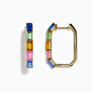 The 14K Yellow Gold Multi Color Sapphire Huggie Earrings feature rectangular sapphires in blue, green, pink, and orange set vertically along each hoop, shown against a white background.