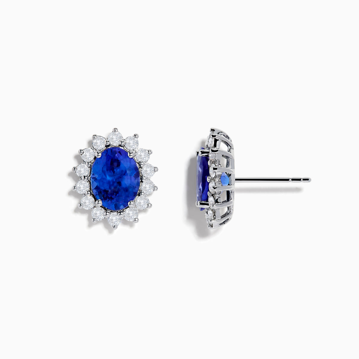 The Nahla Siri 14K White Gold Tanzanite and Diamond Earrings feature oval tanzanite stones surrounded by a halo of sparkling diamonds, elegantly set in white gold and displayed on a white background.
