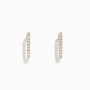 The D'Oro 14K Yellow Gold Diamond Square Huggie Earrings feature a vertical row of sparkling diamonds, beautifully set in gold and photographed on a plain white background.