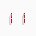 The Ruby Royale 14K Yellow Gold Ruby and Diamond Square Huggie Earrings feature slim bars set with alternating red rubies and clear diamonds, shown against a plain white background.