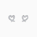 The 14K White Gold Diamond Heart Earrings feature sparkling gemstones and are shown against a white background.
