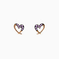 A pair of 14K rose gold multi sapphire heart earrings are shown on a white background.