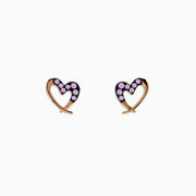 A pair of 14K rose gold multi sapphire heart earrings are shown on a white background.
