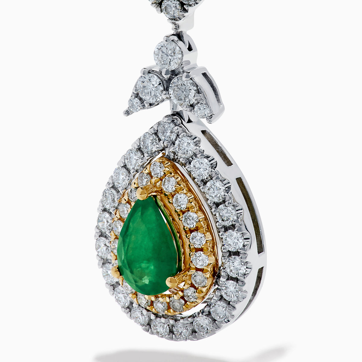 Chic 14K two tone gold statement earrings featuring double pear emeralds, concentric rows of white and yellow diamonds, and a delicate diamond bow—elegant emerald and diamond earrings for any occasion.