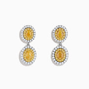 The Canare 18K Two Tone Gold White & Yellow Gold Earrings feature two oval yellow gemstones on each earring, surrounded by small white stones, set in white and yellow gold, displayed against a plain white background.