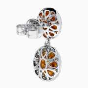 The Canare 18K Two Tone Gold White & Yellow Gold Earrings feature two oval yellow gemstones on each earring, surrounded by small white stones, set in white and yellow gold, displayed against a plain white background.