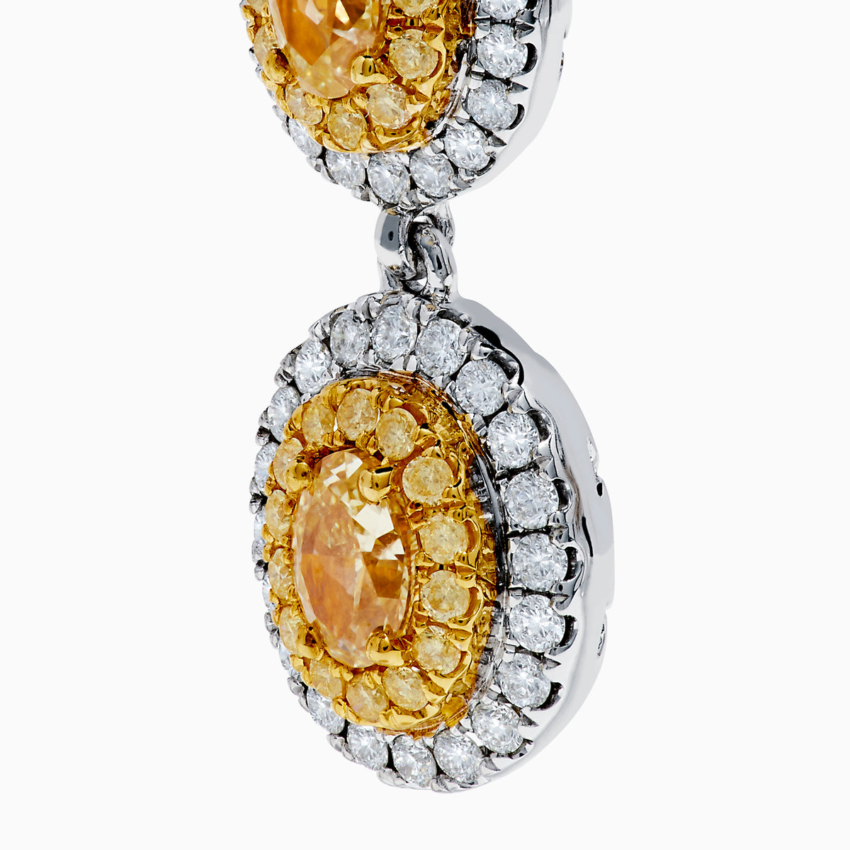 The Canare 18K Two Tone Gold White & Yellow Gold Earrings feature two oval yellow gemstones on each earring, surrounded by small white stones, set in white and yellow gold, displayed against a plain white background.
