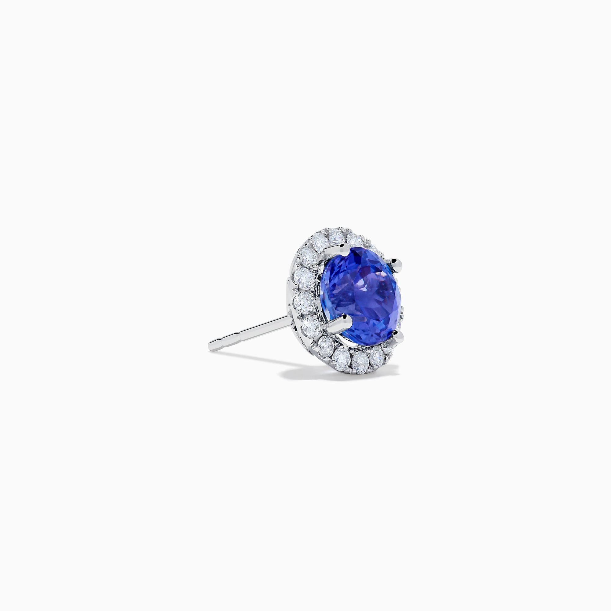 The Nahla 14K White Gold Tanzanite and Diamond Stud Earrings feature round deep blue tanzanite centers, each surrounded by a halo of sparkling white diamonds, beautifully set in 14K white gold against a crisp white background.