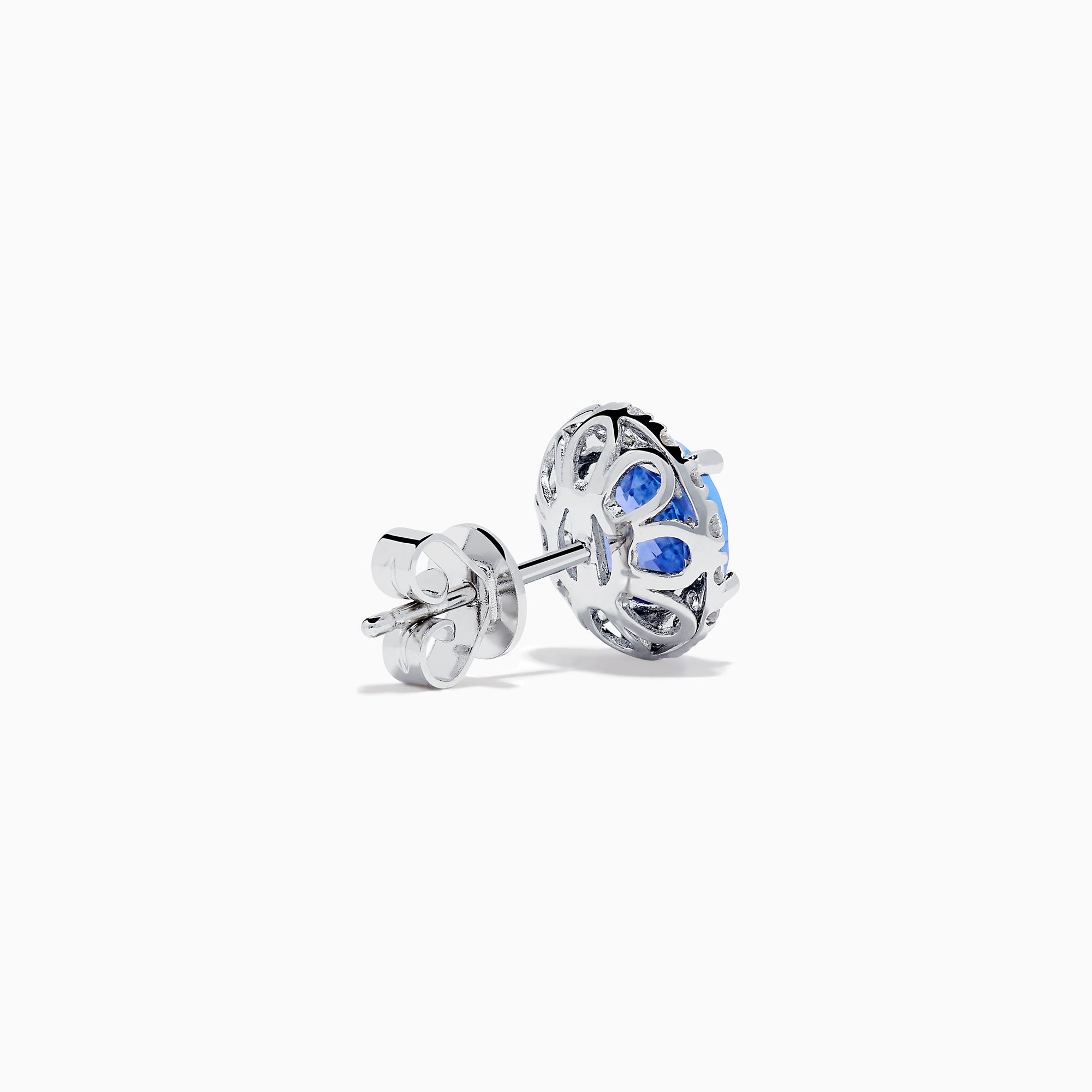The Nahla 14K White Gold Tanzanite and Diamond Stud Earrings feature round deep blue tanzanite centers, each surrounded by a halo of sparkling white diamonds, beautifully set in 14K white gold against a crisp white background.