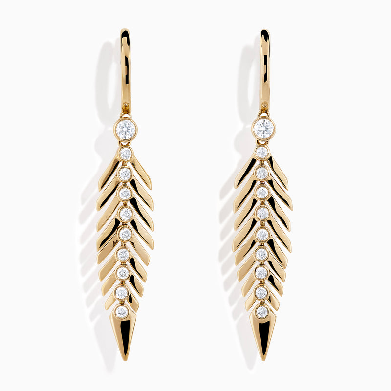 The 14K Yellow Gold Diamond Feather Dangle Earrings feature a leaf-inspired design with sparkling diamonds along the center, shown against a plain white background.