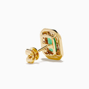 The 14K Yellow Gold Emerald and Diamond Halo Stud Earrings feature rectangular emerald-green stones surrounded by a sparkling diamond halo, set in yellow gold and shown against a white background.